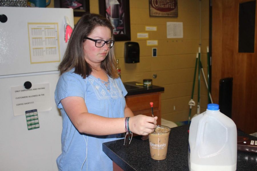 
Senior Erin Peters, a peer facilitator, makes a vanilla iced coffee for a customer at Café Chief A Latte.  Students joined the coffee shop staff as part of the peer facilitation class in which they interact with special needs students.  