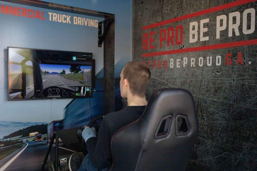 A student uses an 18-wheeler simulator to experience what it is like to drive one. Be Pro Be Proud wants to give students the chance to learn more about the workforce.