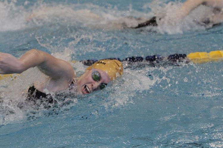 Friedrichs competing in a state meet. Friedrichs wore her Sequoyah swim cap to show school pride.