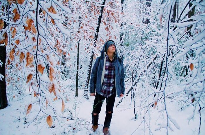 Senior Kalin Valone stands amidst a snowy landscape, gazing at the white vastness. Valone chose this spot for its quietness and lack of objects in the background that would distract from the photograph’s composition. Photo provided by Kalin Valone.