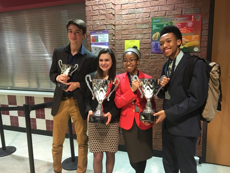 Scott Benefield, Rebekah Carnes, Nyla Crayton, and Caleb Crayton poses with their trophies. Benefield got sixth place and Carnes got first place in the Humorous Interpretation event of speech while the Craytons got second place in the Public Forum. 