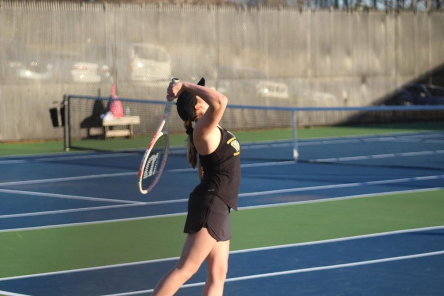 Ava Wallace takes a backhand overhead smash against her opponent. Back hand overhead smash is used when a high ball comes in range.