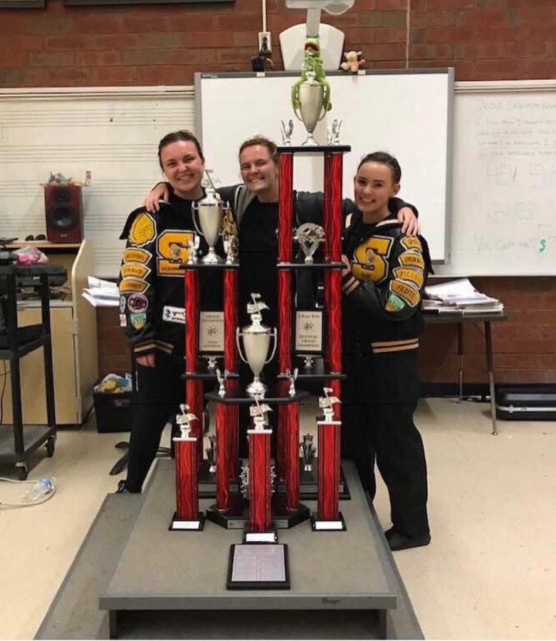 Senior Hannah Becker, junior Cassie Myers, and senior Mackenzie Weston show off the Grand Champion award from the Greater Atlanta Marching Festival on Oct. 13, 2018. Becker, Myers, and Weston worked hard to become drum majors this year.