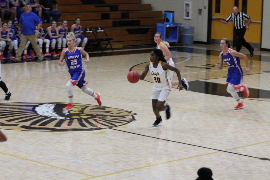 Senior Sydney Rosant dribbles down the court on a fast break. Rosant led the team to a first-round playoff win against Alpharetta.