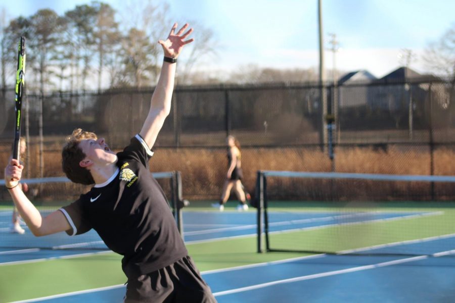 +Bailey+throws+the+tennis+ball+in+the+air+to+serve+the+first+round+of+the+match.+He+made+it+to+State+his+sophomore+year.+