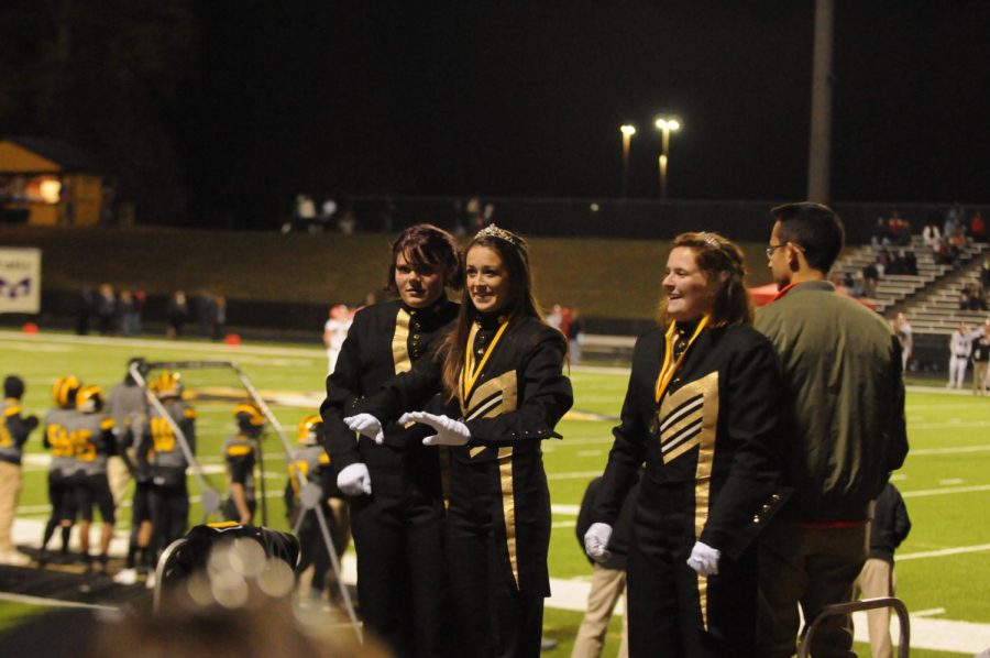Drum majors junior Catie Webb and seniors Cassie Meyers and Madison Joy conduct the band at the final home game of the season against Allatoona High School.  It was the last marching band performance conducted by Myers and Joy. 