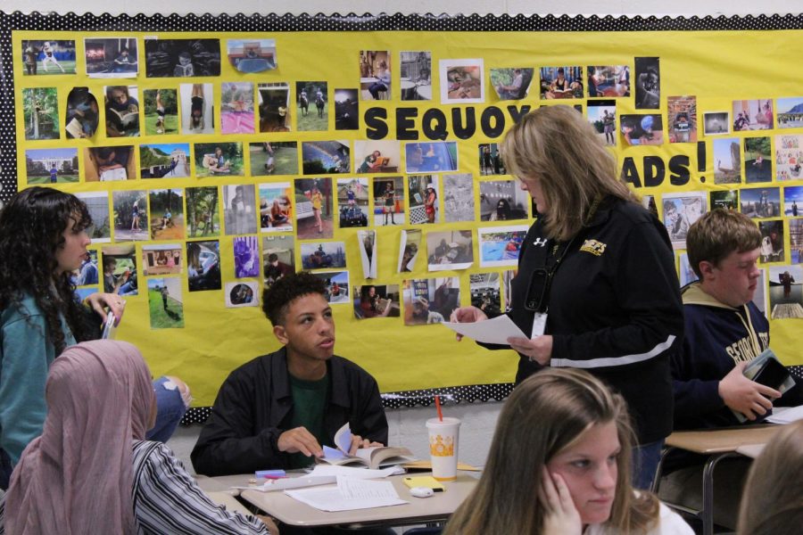 Dr. Cathy Murphy helps a student in her AP Language and Composition class. After the decision on Nov. 7, Murphy’s AP students will no longer have to take the American Literature Milestone. Photo by Grayson Belanger