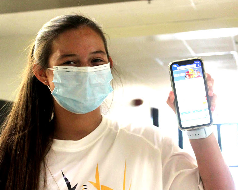 Caroline Small poses with ClickList on her phone. She began using the Kroger prior to the pandemic.