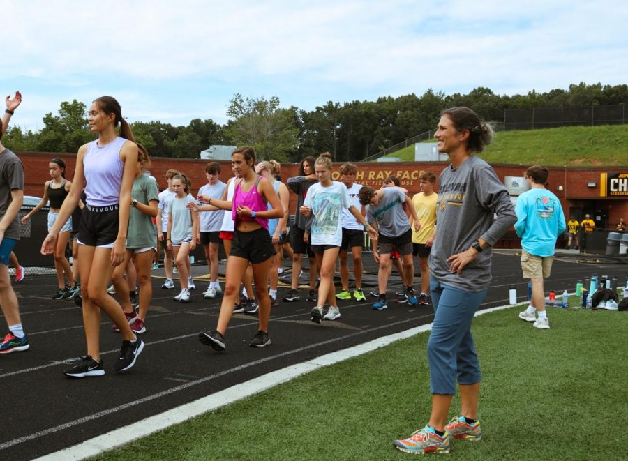 Coach Ingram oversees the warm-ups of the Cross Country team. Ingram has high expectations for her runners this season.
