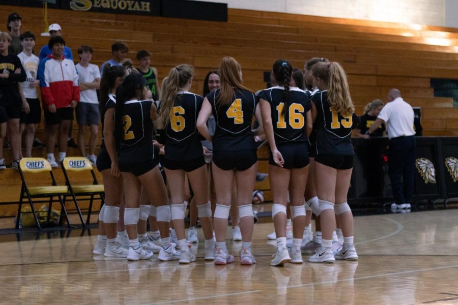 The varsity volleyball team forms a huddle before their second set of the night. The Chiefs swept Chattahoochee 2-0 in their last home game of the regular season.