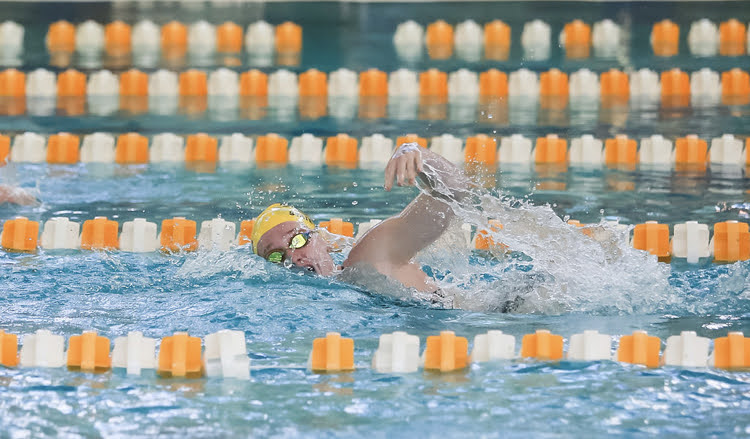 Laurel Blase quickly comes up for breath while swimming freestyle. The girls won their first meet since 2017 last Saturday. Photo provided by Darby Rose Photography.